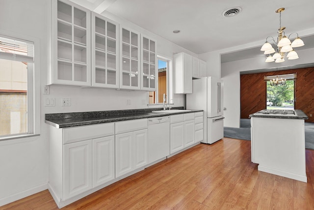 16588 Stanislaus Dr, Redding, CA 96001 - kitchen featuring an inviting chandelier, white appliances, glass insert cabinets, light wood-type flooring, and a sink