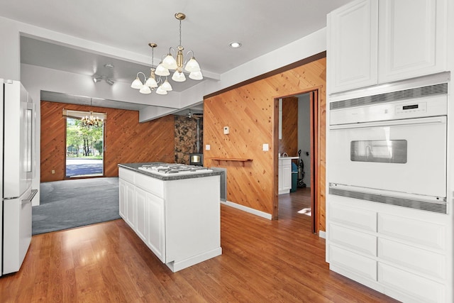 16588 Stanislaus Dr, Redding, CA 96001 - kitchen featuring a chandelier, white appliances, white cabinetry, and wood finished floors