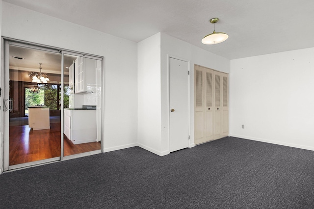 16588 Stanislaus Dr, Redding, CA 96001 - unfurnished bedroom with dark colored carpet, a notable chandelier, and baseboards