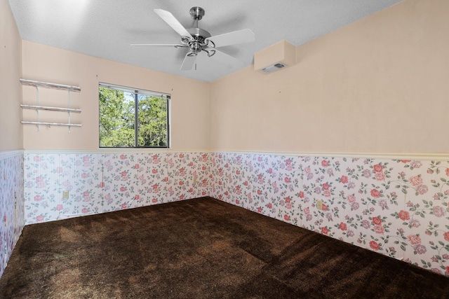 16588 Stanislaus Dr, Redding, CA 96001 - spare room with wallpapered walls, a textured ceiling, a ceiling fan, a wainscoted wall, and carpet floors