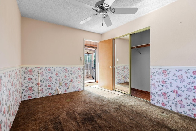 16588 Stanislaus Dr, Redding, CA 96001 - carpeted bedroom with a closet, a textured ceiling, a ceiling fan, and a wainscoted wall