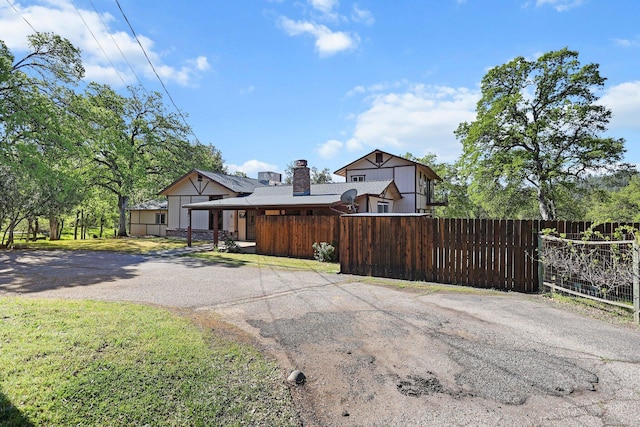 16588 Stanislaus Dr, Redding, CA 96001 - view of front of home with driveway, a chimney, and a fenced front yard