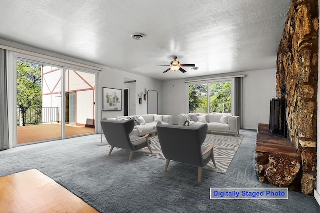 16588 Stanislaus Dr, Redding, CA 96001 - carpeted living room featuring visible vents, a textured ceiling, and ceiling fan