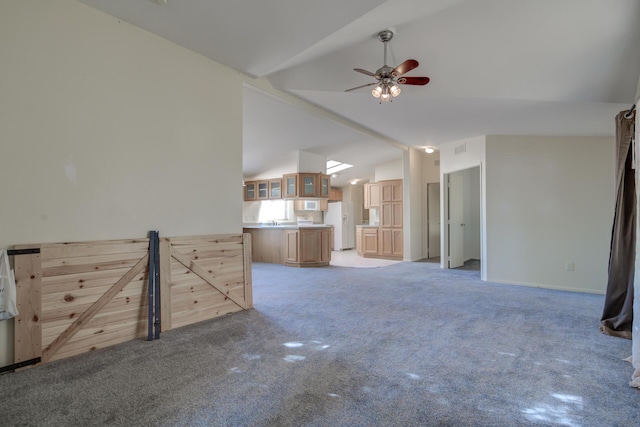 unfurnished living room featuring lofted ceiling, visible vents, a ceiling fan, and light carpet