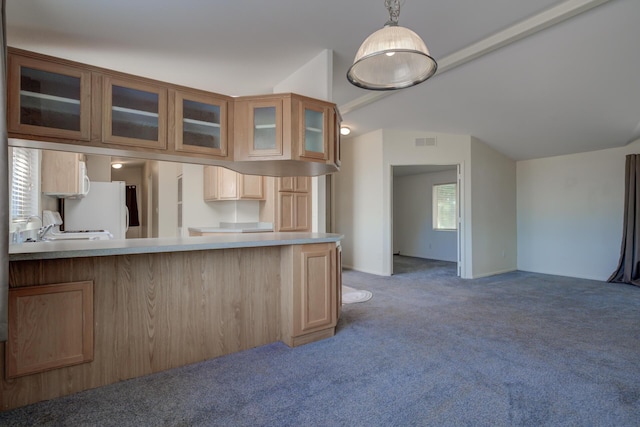 kitchen featuring carpet flooring, glass insert cabinets, visible vents, light countertops, and freestanding refrigerator