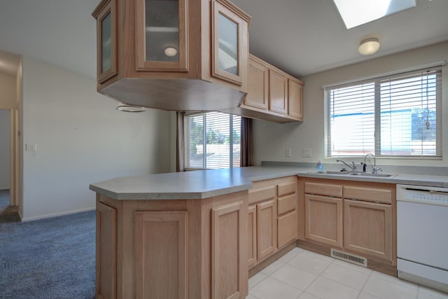 kitchen featuring light brown cabinetry, white dishwasher, a sink, visible vents, and a peninsula