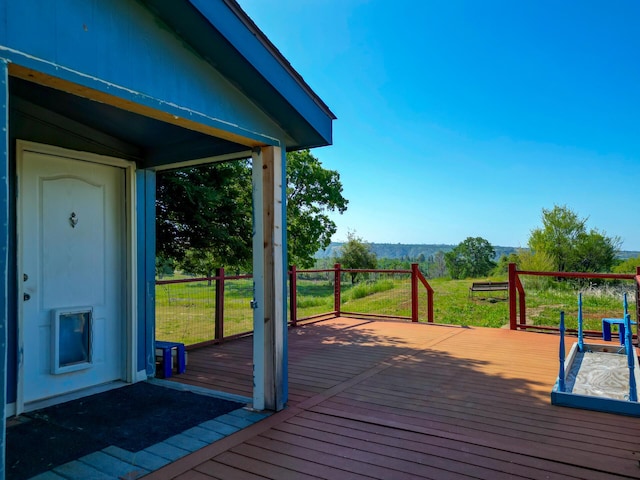 deck with a mountain view and a lawn