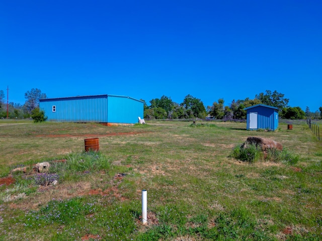 view of yard with a shed and an outbuilding