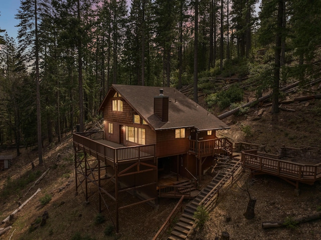 2120 Pack Trl, Mount Shasta, CA 96067 - rear view of house featuring a wooded view, stairway, roof with shingles, a chimney, and a deck