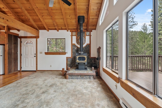 2120 Pack Trl, Mount Shasta, CA 96067 - living area featuring a wood stove, a ceiling fan, wood ceiling, a baseboard heating unit, and baseboards