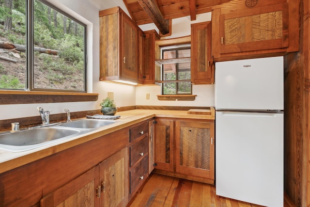 2120 Pack Trl, Mount Shasta, CA 96067 - kitchen featuring beamed ceiling, freestanding refrigerator, a sink, and a healthy amount of sunlight