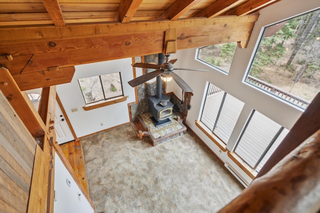 2120 Pack Trl, Mount Shasta, CA 96067 - unfurnished living room with carpet floors, a wood stove, beam ceiling, a baseboard radiator, and wood ceiling