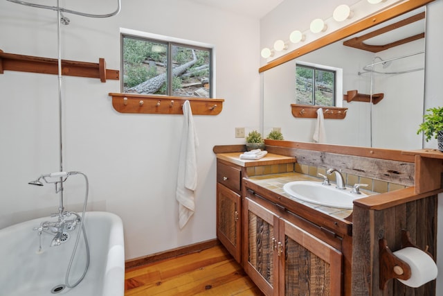 2120 Pack Trl, Mount Shasta, CA 96067 - full bathroom with wood finished floors, vanity, a freestanding tub, and a wealth of natural light
