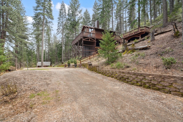 2120 Pack Trl, Mount Shasta, CA 96067 - view of home's exterior with a deck, driveway, and a chimney