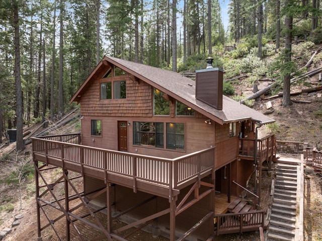 2120 Pack Trl, Mount Shasta, CA 96067 - rear view of property featuring stairs, a wooden deck, a chimney, and a shingled roof