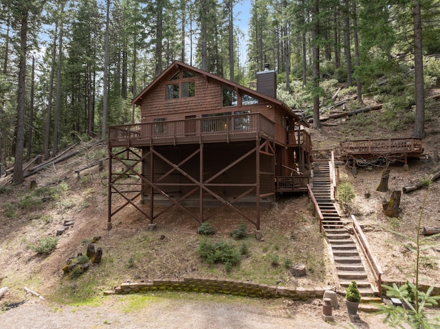 2120 Pack Trl, Mount Shasta, CA 96067 - rear view of house with a wooden deck, stairs, and a chimney