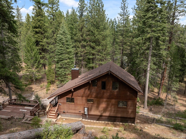 2120 Pack Trl, Mount Shasta, CA 96067 - view of side of property with a deck, a forest view, and a chimney