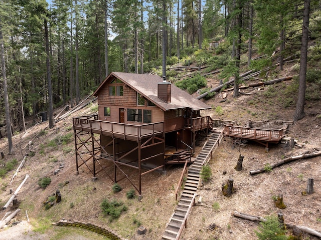 2120 Pack Trl, Mount Shasta, CA 96067 - rear view of house with roof with shingles, a chimney, a wooden deck, and stairs