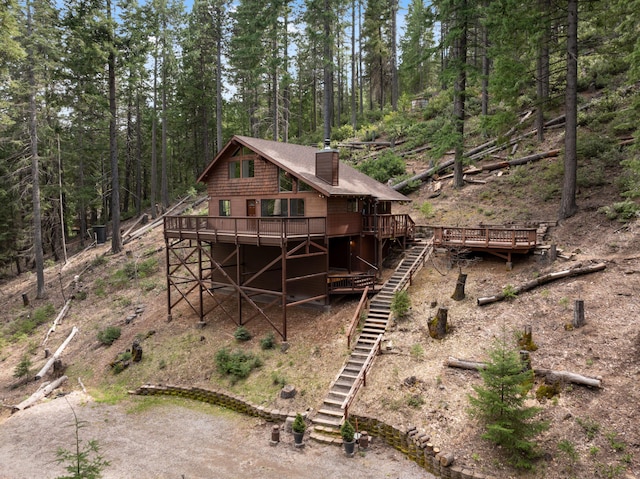 2120 Pack Trl, Mount Shasta, CA 96067 - back of house featuring a forest view, stairway, a deck, and a chimney