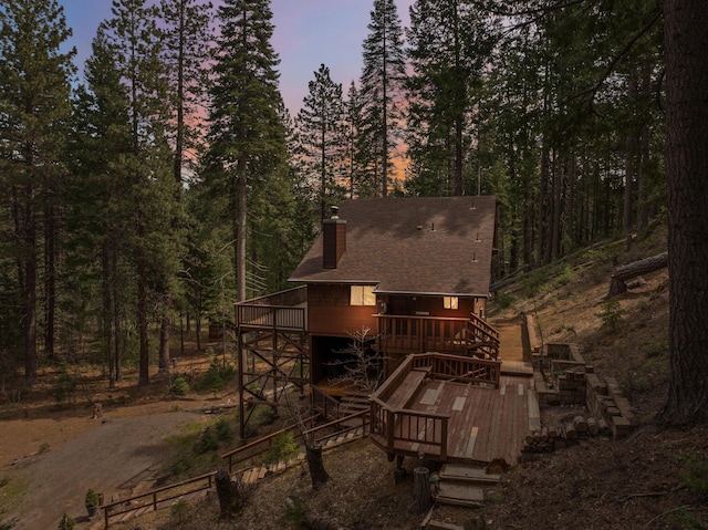 2120 Pack Trl, Mount Shasta, CA 96067 - rear view of house featuring a view of trees, stairway, roof with shingles, a chimney, and a deck
