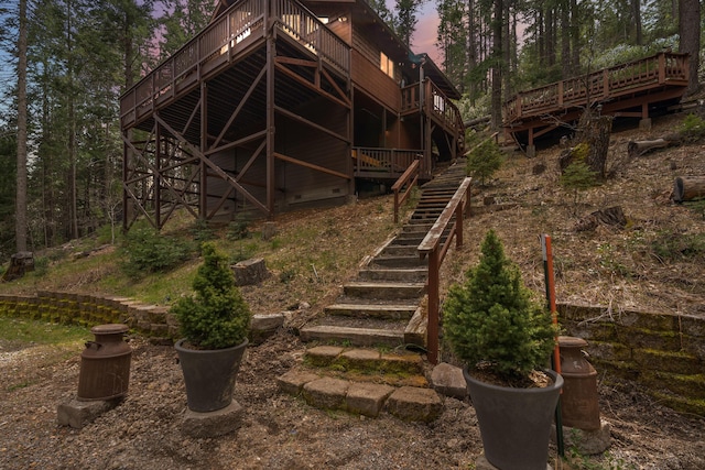 2120 Pack Trl, Mount Shasta, CA 96067 - back of house at dusk featuring a deck and stairway
