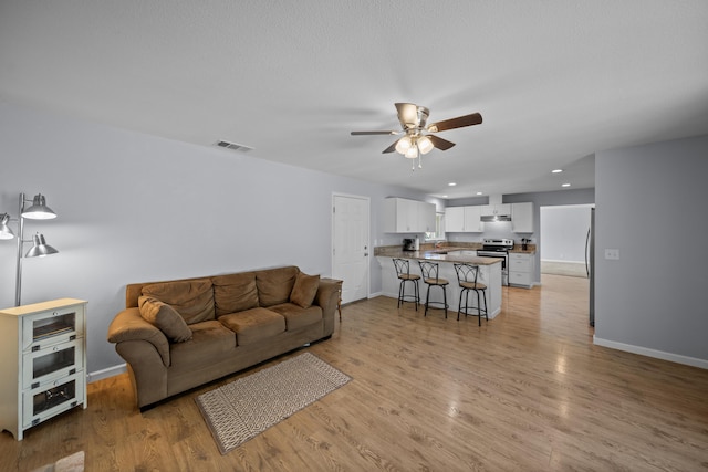 20035 Old Alturas Rd, Redding, CA 96003 - living room with visible vents, baseboards, recessed lighting, a ceiling fan, and light wood-style flooring
