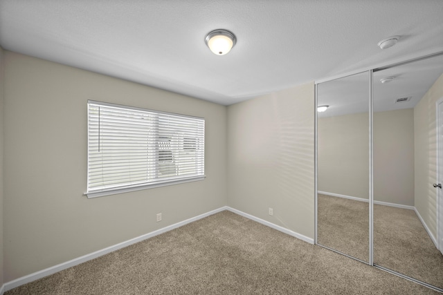20035 Old Alturas Rd, Redding, CA 96003 - unfurnished bedroom featuring a closet, carpet, baseboards, and visible vents
