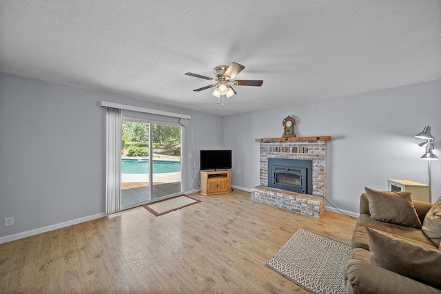 20035 Old Alturas Rd, Redding, CA 96003 - living room featuring a brick fireplace, a ceiling fan, baseboards, and wood finished floors