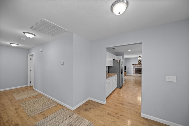 20035 Old Alturas Rd, Redding, CA 96003 - corridor with baseboards, light wood-style flooring, and visible vents