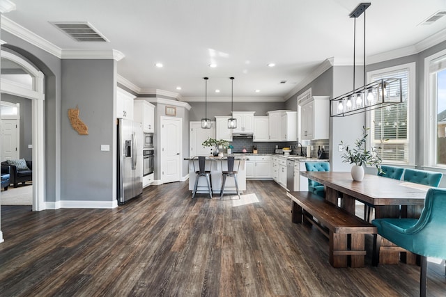 2796 Madison River Dr, Redding, CA 96002 - dining space with recessed lighting, visible vents, ornamental molding, and dark wood finished floors