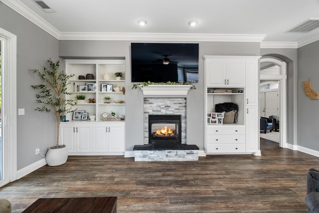 2796 Madison River Dr, Redding, CA 96002 - living area with a lit fireplace, crown molding, visible vents, and arched walkways