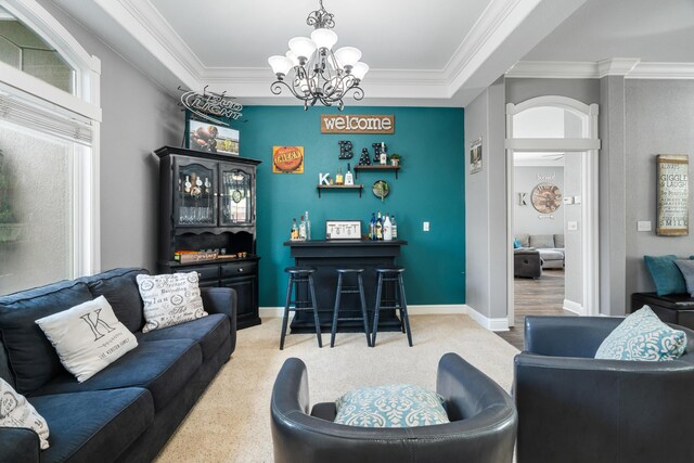 2796 Madison River Dr, Redding, CA 96002 - carpeted living area with a chandelier, crown molding, a dry bar, and baseboards