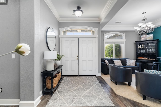 2796 Madison River Dr, Redding, CA 96002 - entrance foyer with ornamental molding, plenty of natural light, a chandelier, and wood finished floors