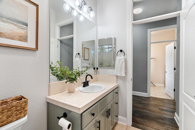 2796 Madison River Dr, Redding, CA 96002 - bathroom with baseboards, vanity, and wood finished floors