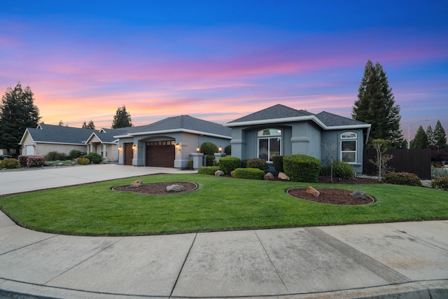 2796 Madison River Dr, Redding, CA 96002 - ranch-style home featuring concrete driveway, stucco siding, an attached garage, a front lawn, and fence