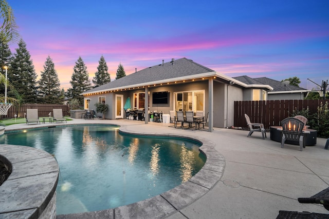 2796 Madison River Dr, Redding, CA 96002 - pool at dusk with an outdoor fire pit, fence, a fenced in pool, and a patio