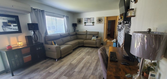 living room with a wall mounted AC and wood finished floors