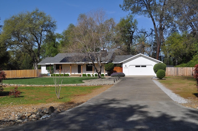 19702 Midland Dr, Redding, CA 96003 - ranch-style home with an attached garage, aphalt driveway, a front yard, and fence
