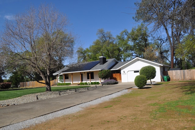 19702 Midland Dr, Redding, CA 96003 - ranch-style house with concrete driveway, a front yard, fence, and an attached garage