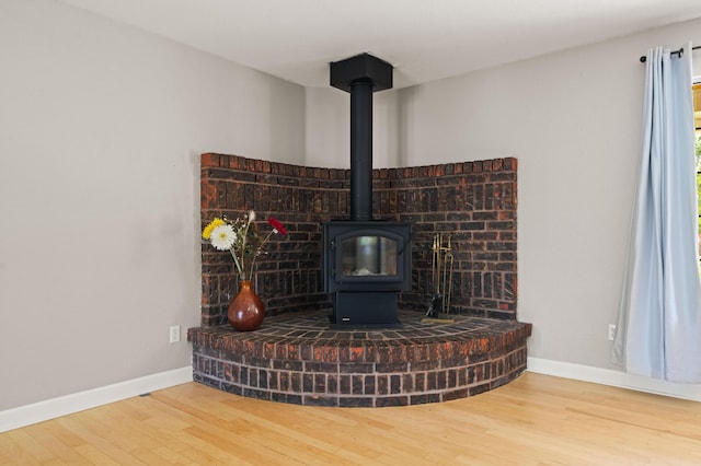19702 Midland Dr, Redding, CA 96003 - interior details featuring a wood stove, baseboards, and wood finished floors