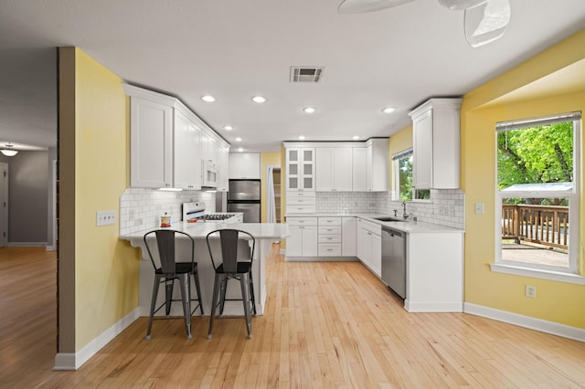 19702 Midland Dr, Redding, CA 96003 - kitchen with a peninsula, a sink, baseboards, and stainless steel appliances