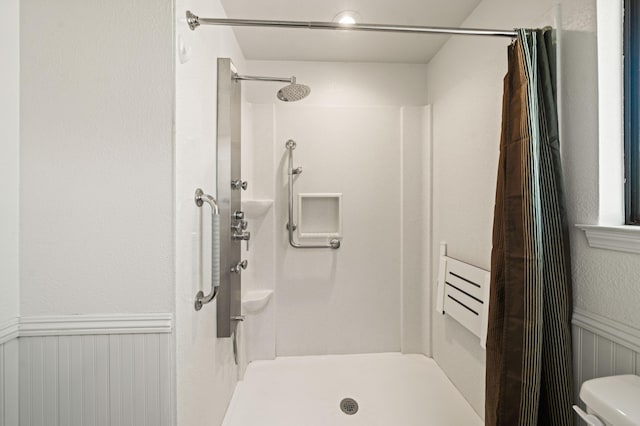 19702 Midland Dr, Redding, CA 96003 - full bathroom with toilet, a wainscoted wall, and a shower stall