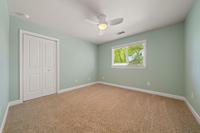 19702 Midland Dr, Redding, CA 96003 - unfurnished bedroom with a closet, baseboards, visible vents, ceiling fan, and carpet