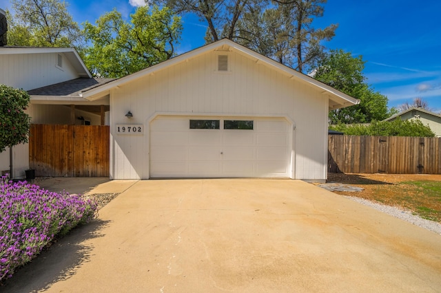 19702 Midland Dr, Redding, CA 96003 - garage featuring concrete driveway and fence
