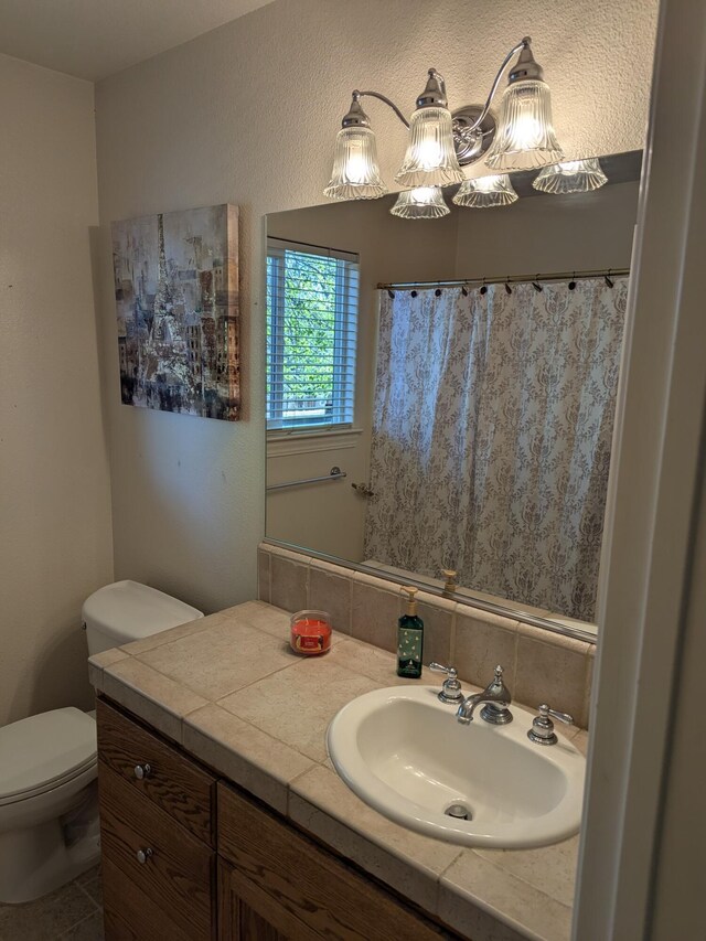 full bath featuring toilet, curtained shower, and vanity