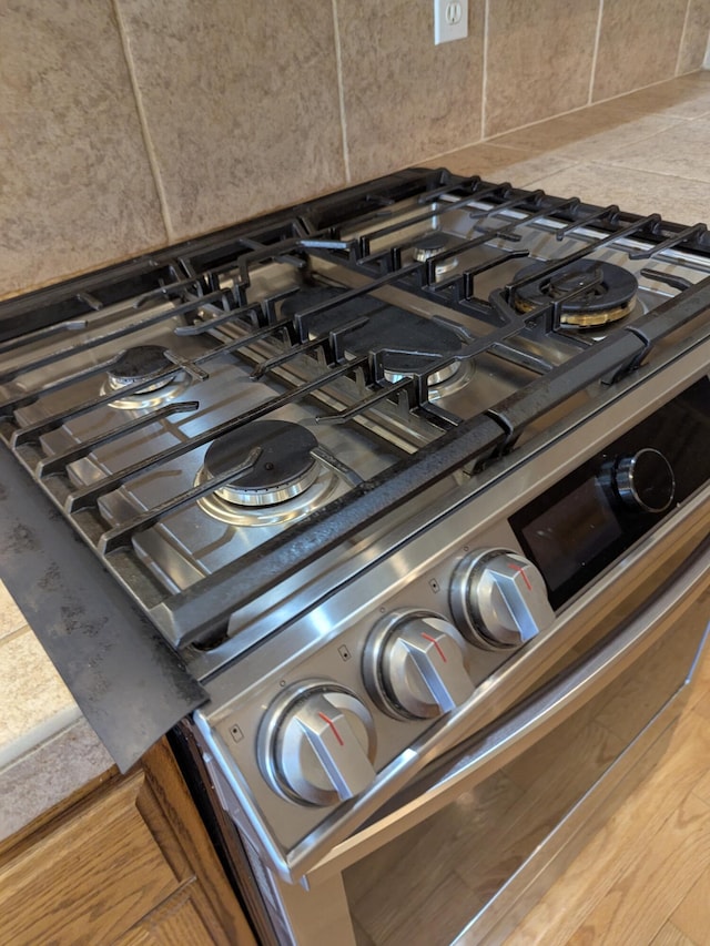 details with gas range and backsplash