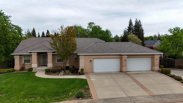 ranch-style house featuring a front yard, driveway, stucco siding, and an attached garage
