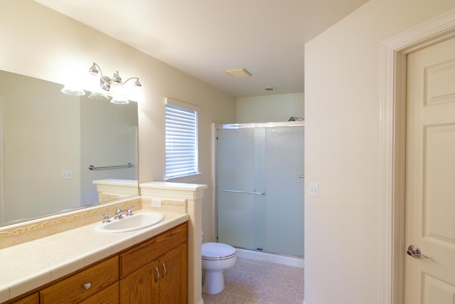full bath featuring toilet, a stall shower, and vanity