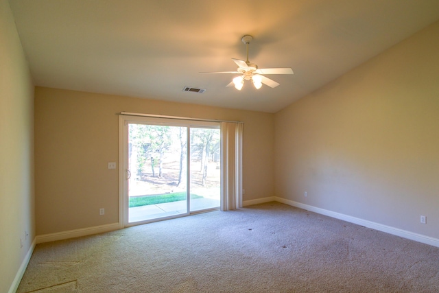 carpeted spare room featuring a ceiling fan, baseboards, lofted ceiling, and visible vents