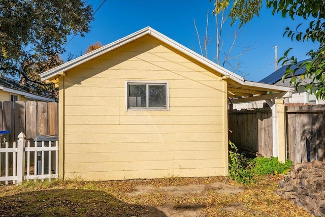 view of side of home featuring fence